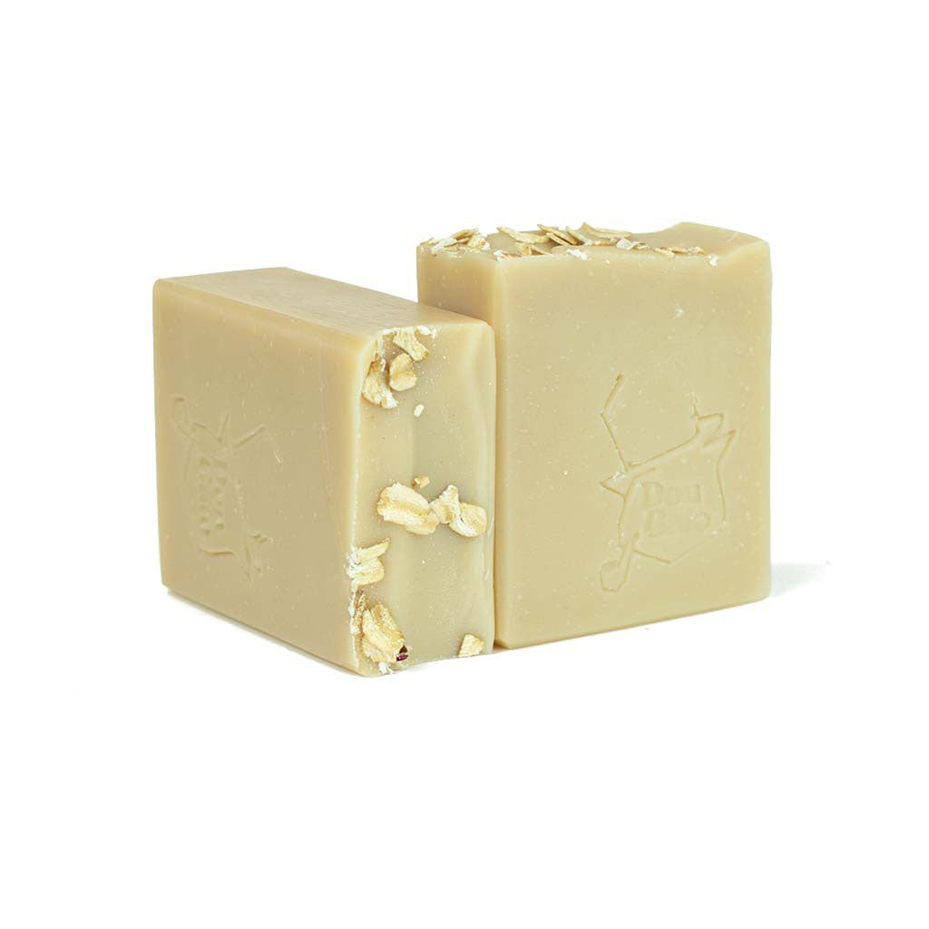 Don Gato oatmeal artisan soap bar with oat flakes on top, creamy beige, on white background.