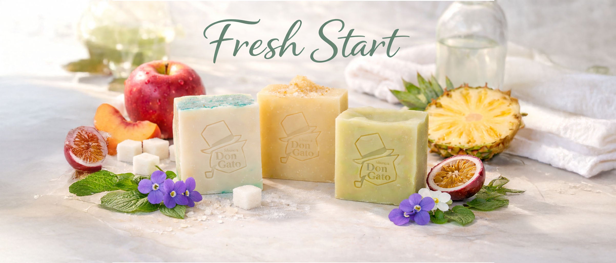 Artisan soap bars by Don Gato Soap Co. styled with fresh fruits and botanicals, photographed in bright natural light to evoke a Fresh Start ritual.