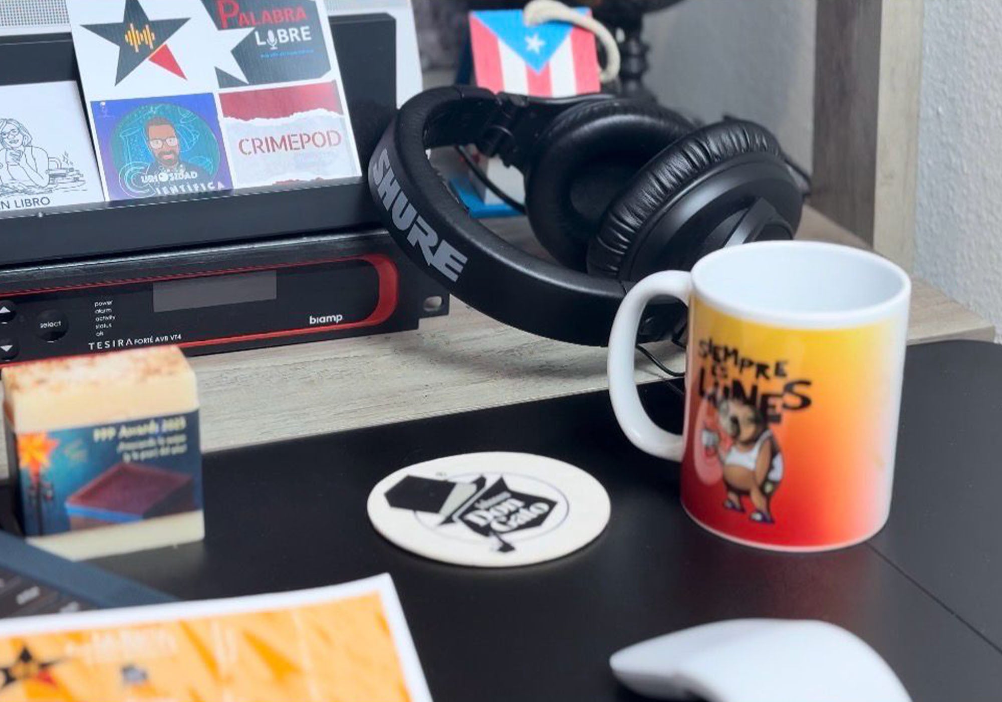 Creative workspace with headphones, podcast equipment, books, and Don Gato Soap Co. objects referencing podcast collaborations, photographed in natural light.