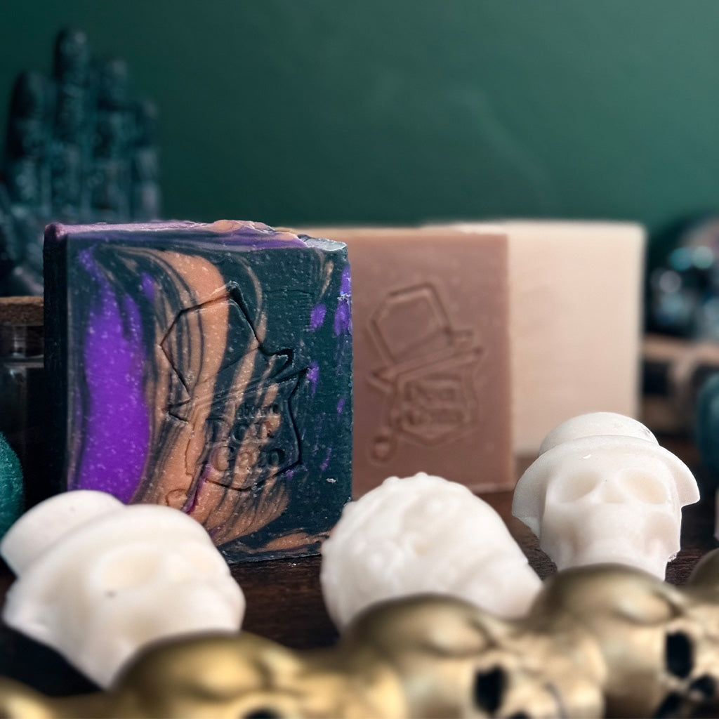 The Witching Hour Artisan Soap collection cover with swirled soap and embossed Don Gato label, displayed with skulls.