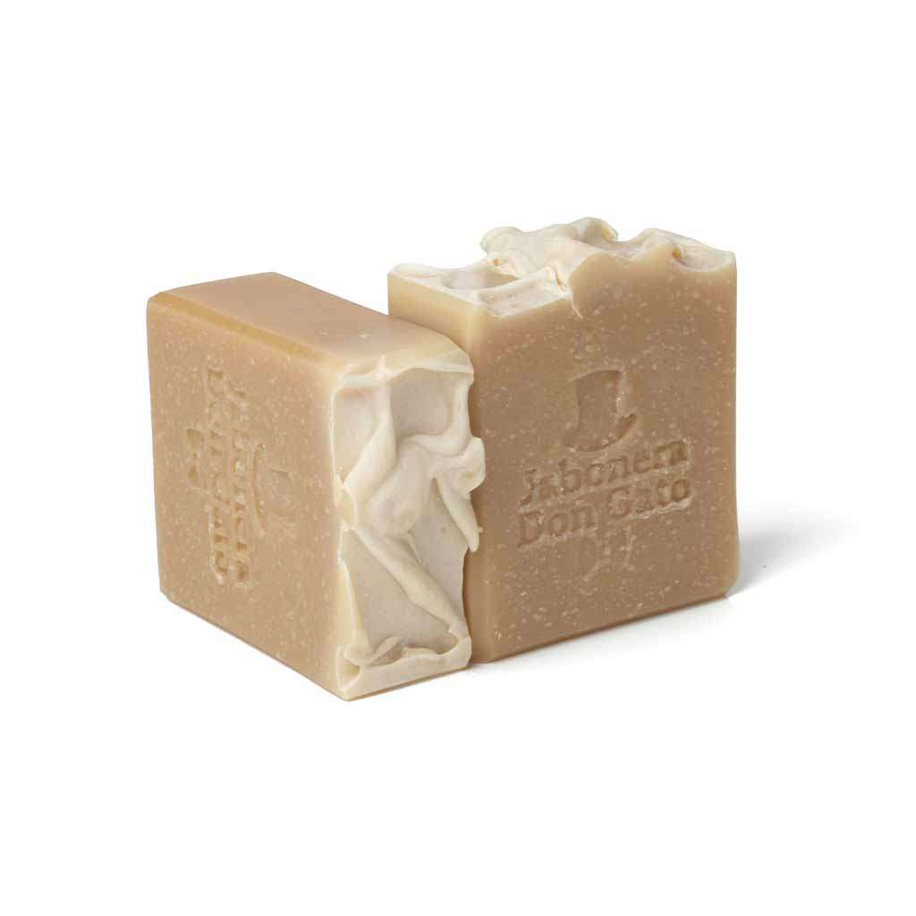 Two bars of Goat Milk Artisan Soap, showcasing a smooth, creamy texture and natural ivory color, set against a pure white background, emphasizing the gentle, moisturizing benefits of the handcrafted soap.