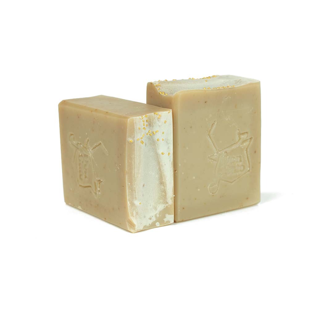 Almond Artisan Soap bar in beige with golden speckles, embossed Don Gato logo, almond and cherry scent.