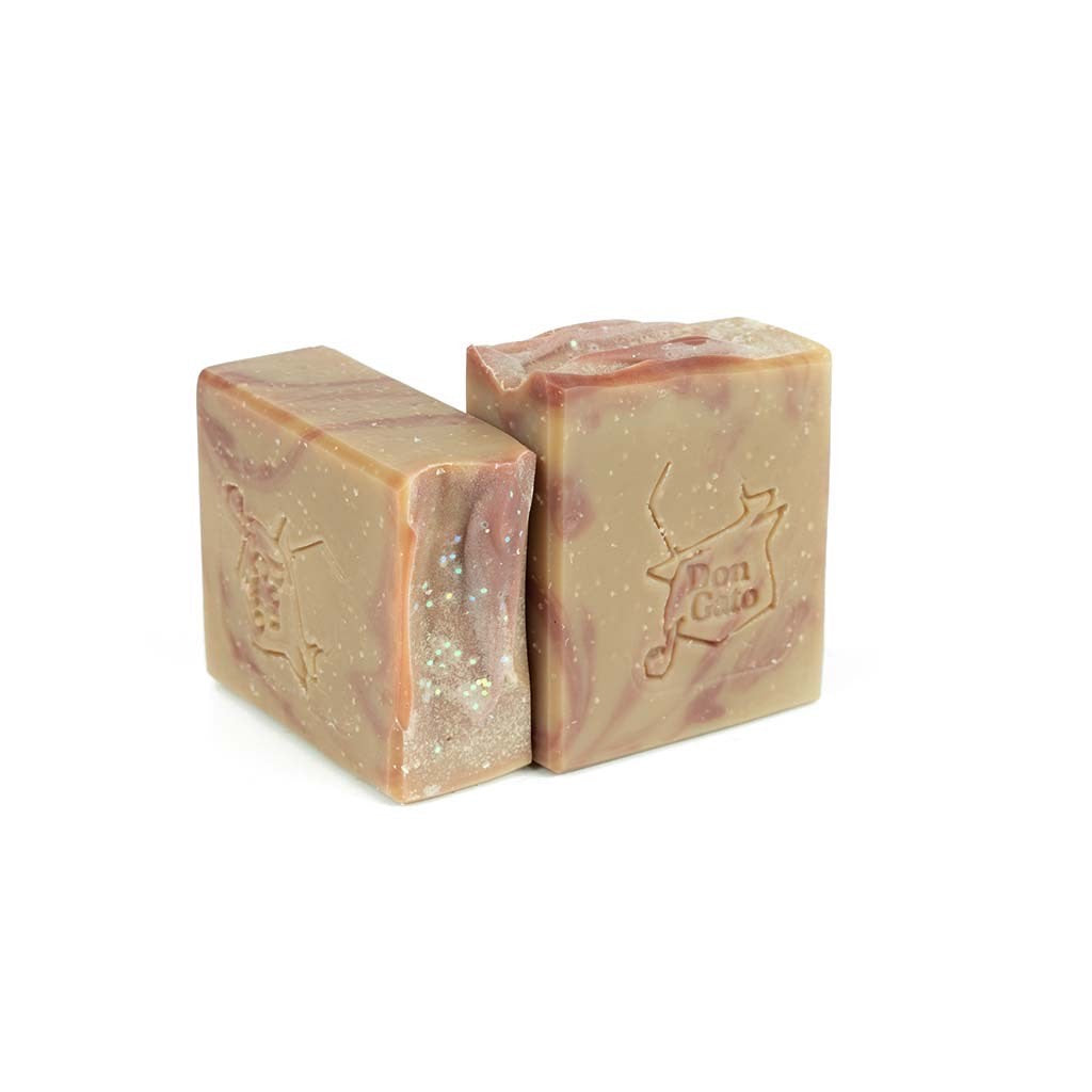Coconut Sandalwood artisan soap by Jabonera Don Gato from the Bestsellers collection with soft brown and pink swirls and subtle shimmer on white background.
