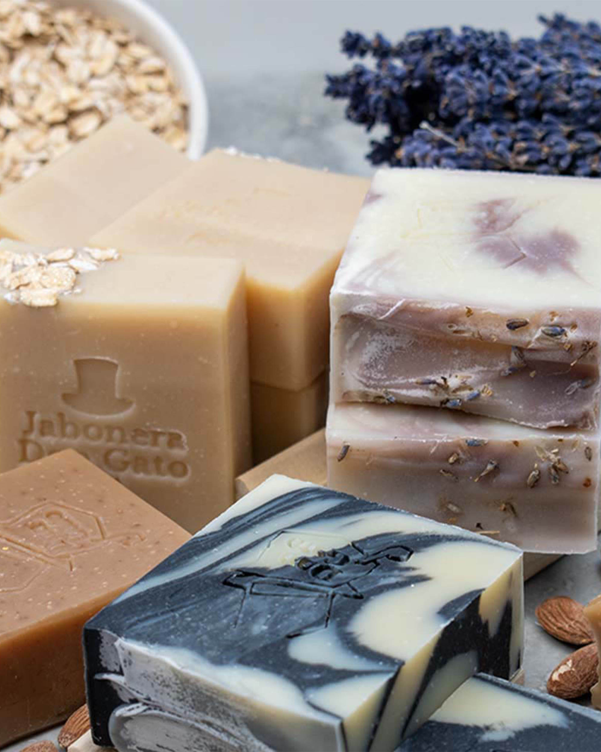 Artisan soap bars by Don Gato Soap Co. featuring expressive colors and textures, photographed in bright natural light.

