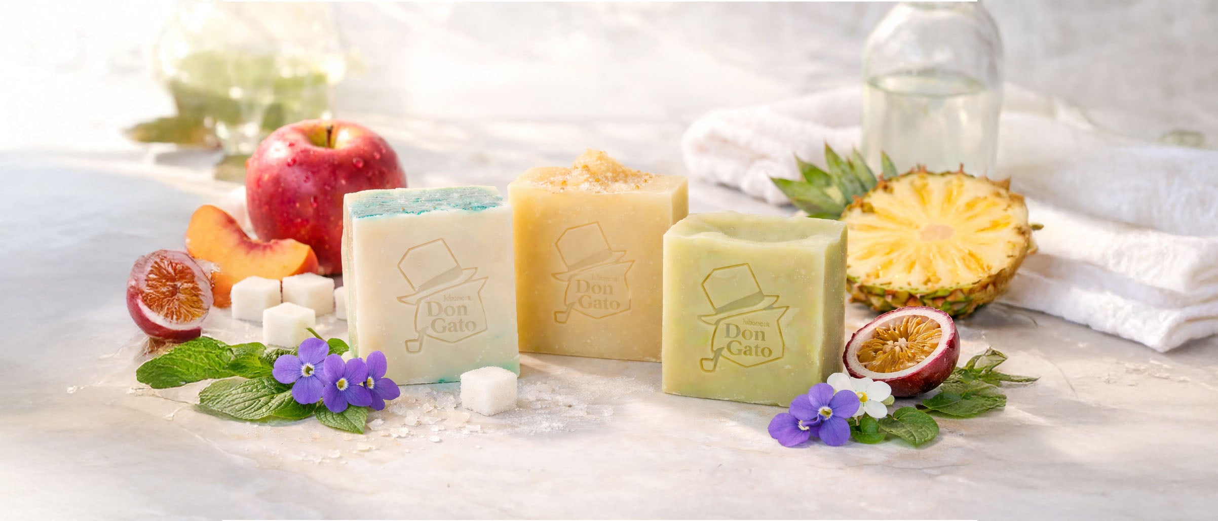 Artisan soap bars by Don Gato Soap Co. styled with fresh fruits and botanicals, photographed in bright natural light to evoke a Fresh Start ritual.

