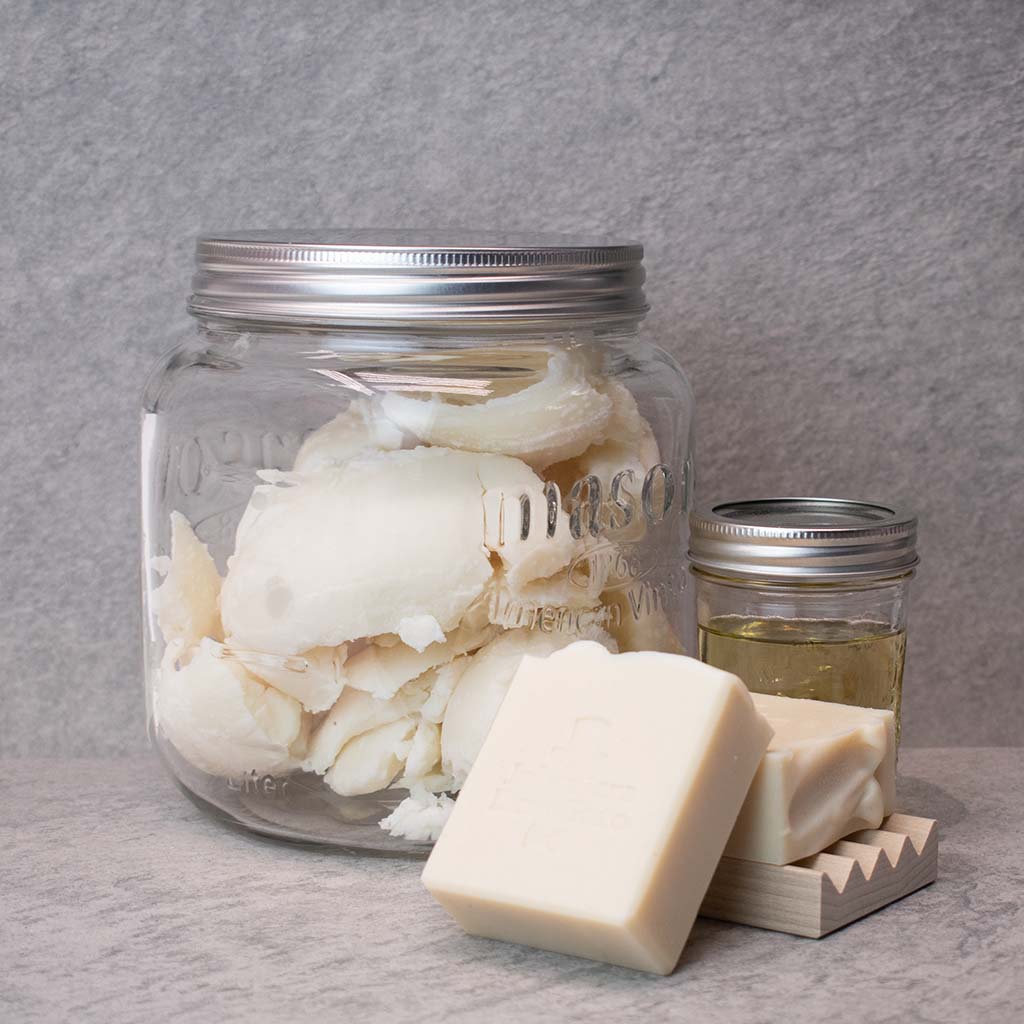 Unscented natural soap with shea butter and oil jars, fragrance-free.